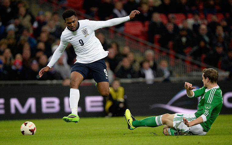 England and germany: Marcell Jansen tackles Daniel Sturridge just as he prepares to shoot 