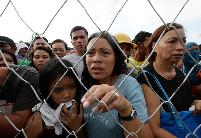 From the agencies: Residents queue up to receive relief supplies at Tacloban airport 
