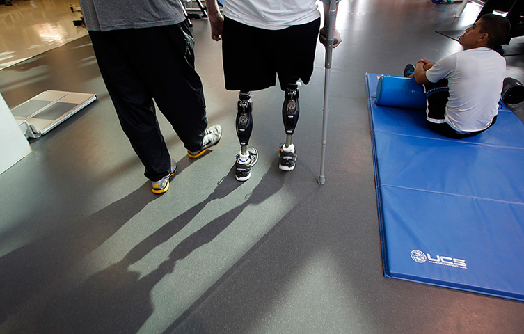 Sgt Matt Krumwiede: Krumwiede practices walking with his physical therapist Troy Hopkins at the