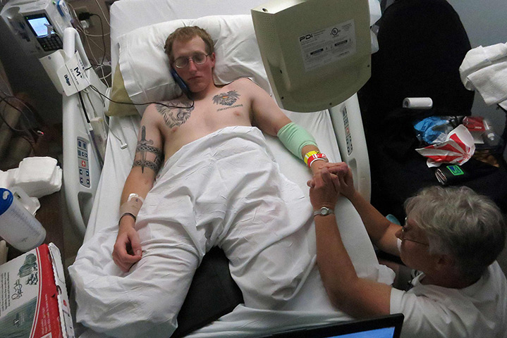 Sgt Matt Krumwiede: Krumwiede takes a phone call as his hand is massaged by his mother Pam Krum