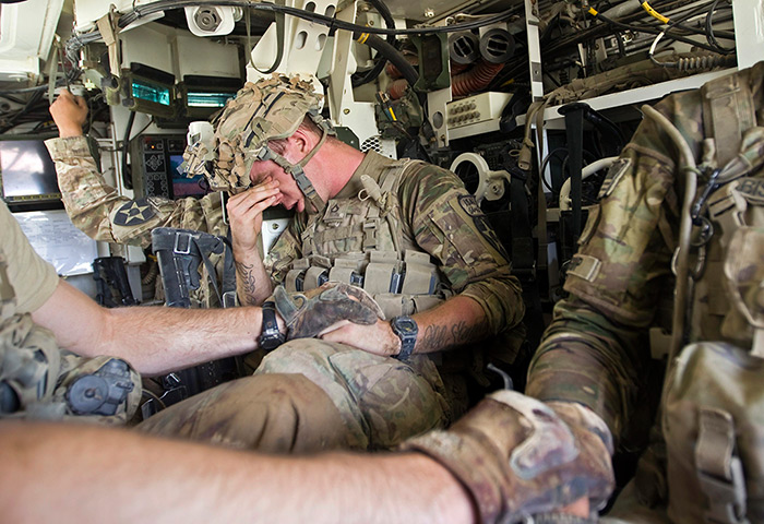 Sgt Matt Krumwiede: A US Army soldier reacts as he sits inside an armoured vehicle after his co