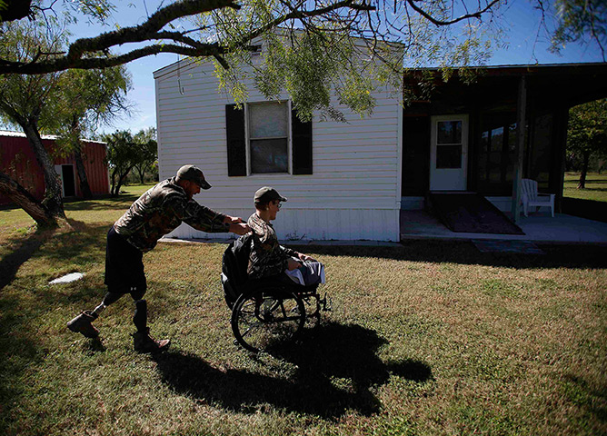 Sgt Matt Krumwiede: Krumwiede sits in his wheelchair as he is pushed by his friend Sgt Jesse Mc