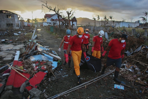 A Red Cross rescue team recovers a body from the devastated city of Tacloban. 