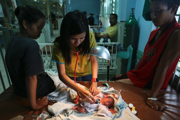 A doctor gives medical attention to a newborn baby with an infection in the pediatric ward of the overcrowded Eastern Visayas Medical Centre in Tacloban. Devastation to transport infrastructure has hampered the delivery of aid causing growing health concerns.