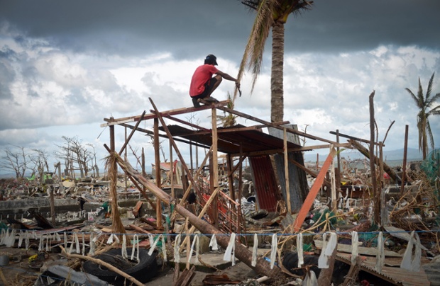 A man tries to rebuild his home near the shoreline in Tacloban.