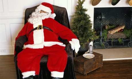 santa asleep next to empty plate of cookies