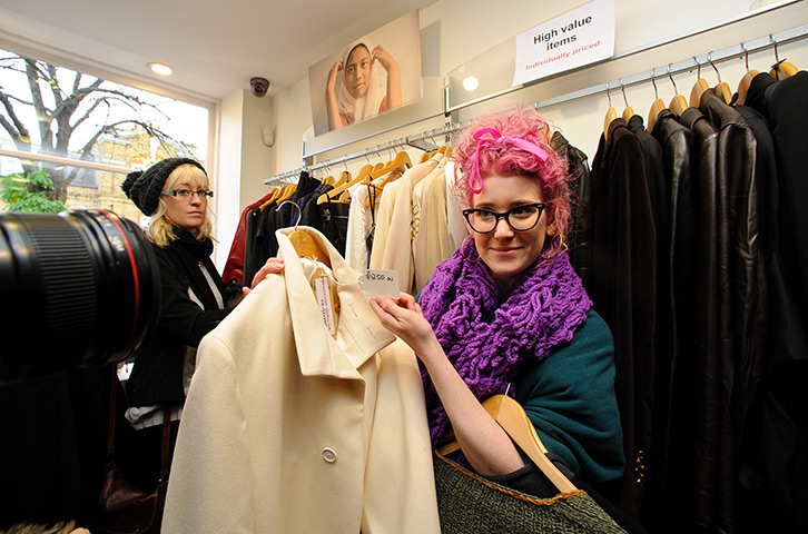 Beckhams' clothes sale: A shopper looking at a coat