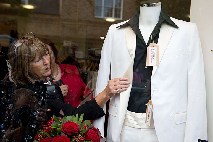 Beckhams' clothes sale: Shop workers make final adjustments to the window display