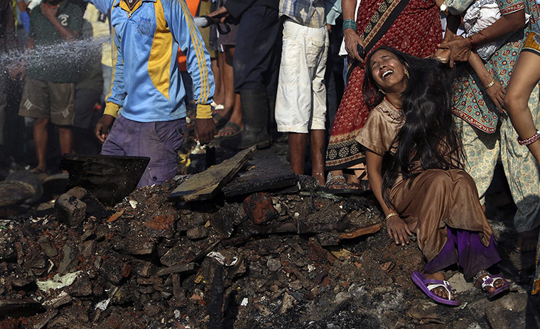 20 Photos: A woman cries after a fire in Ambedkar Nagar slum in Mumbai, India