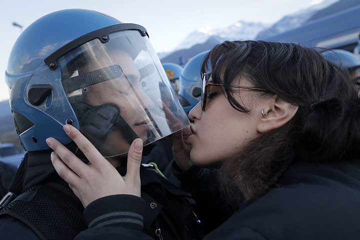 20 Photos: A demonstrator kisses a riot police officer during a protest in Susa, Italy