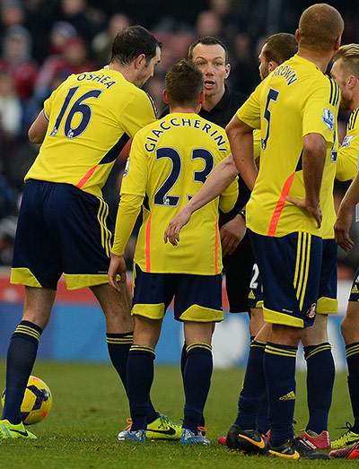 saturday roundup: Referee Kevin Friend is surrounded by Sunderland players