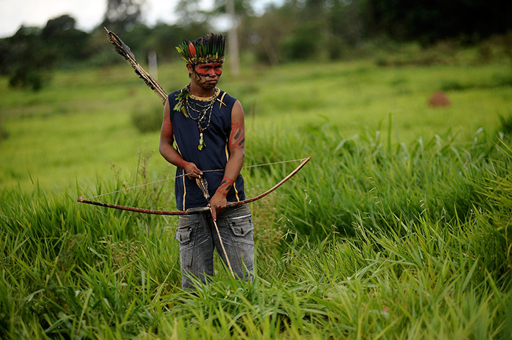 Weekend in pictures: Japora, Brazil: A member of the Guarani Nandeva tribe stands watch at a roa