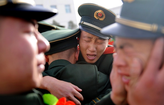 A heartfelt moment is witnessed between Chinese paramilitary policemen as they see off veteran colleagues during a farewell ceremony in Taiyuan, Shanxi province.