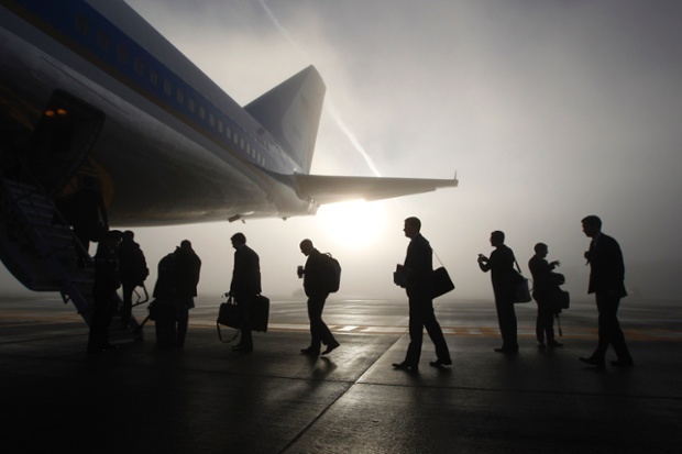 White House staff and press board Air Force One on a foggy morning in Seattle on their way to attend fundraisers and events on the economy and immigration with President Obama in Los Angeles and San Francisco.