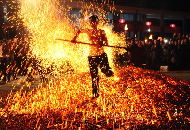 Walking through burning charcoal in a ritual called Lianhuo, or fire walking, in Pan'an county, Zhejiang province in China is seen as as a way to ward off evil and bring luck.