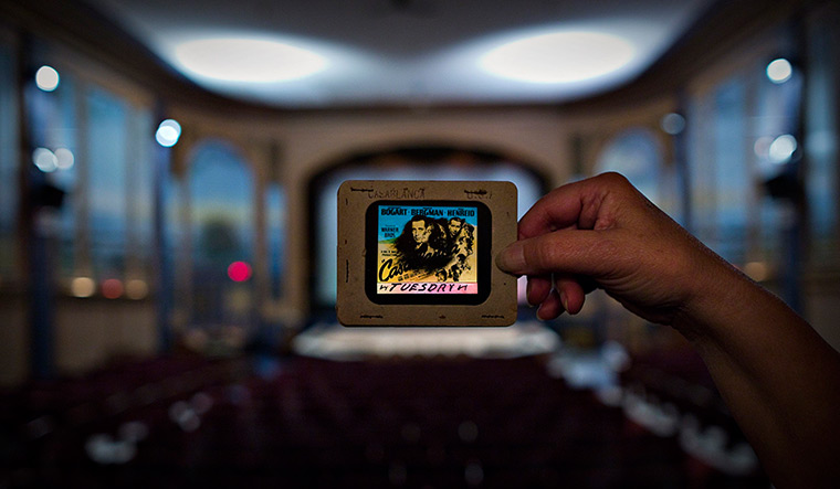 Patricia Theatre: Cinema owner Ann Nelson holds up an original slide from the film Casablanca