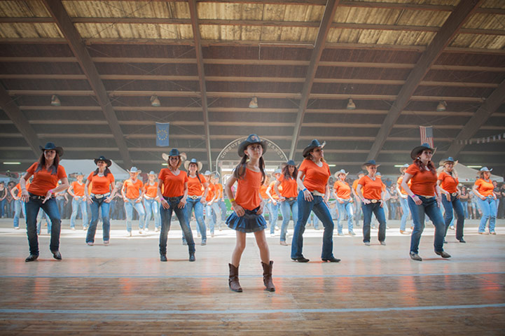Big Picture - Spaghetti: women and children line-dancing wearing orange t-shirts