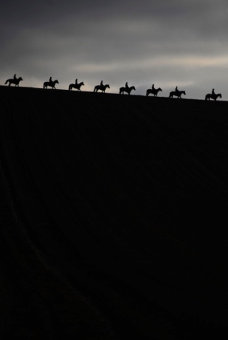 Photographer Alan Crowhurst made sure he was in the right place at the right time to take this striking picture of horses and riders making their way down the gallops at Seven Barrows Stables in Lambourn, England. Great work! Photograph: Alan Crowhurst/Getty Images