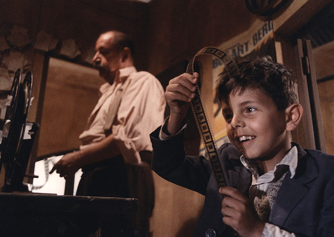 Cinema Paradiso gallery: Cinema Paradiso: Salvatore looks at film negatives in the projector