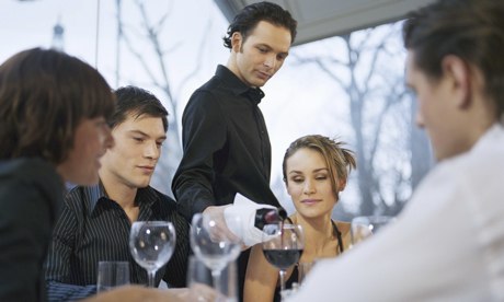 Waiter pouring wine