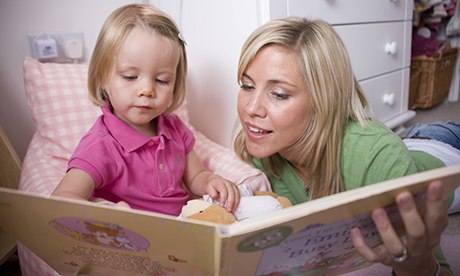 storytelling at bed time - mother and child reading a book