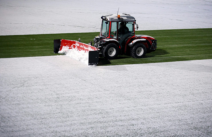 spurs: Tromso ground staff in their heavy machinery clear the snow