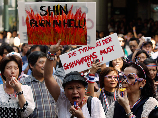 Thailand protests: Protesters blow whistles and hold placards