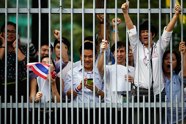 Thailand protests: Office workers cheer as anti-government protesters march past