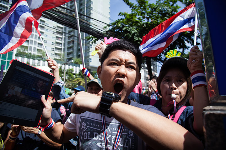 Thailand protests: An anti-government protester shouts at the police line