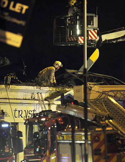 Clutha Bar: Emergency services inspect the roof of a
