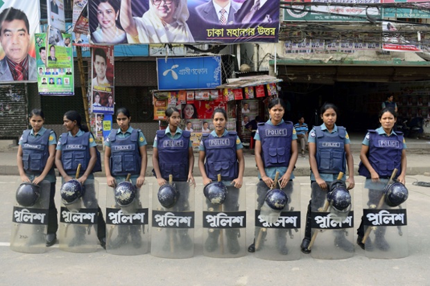 Bangladeshi police officers stand guard during the first day of a nationwide strike called by the opposition Bangladesh Nationalist Party (BNP) in Dhaka. The strike is in demand of a non-party neutral caretaker to conduct the upcoming parliament polls.