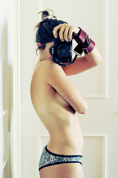 Big Picture - Pregnancy: semi-naked woman taking self-portrait with camera