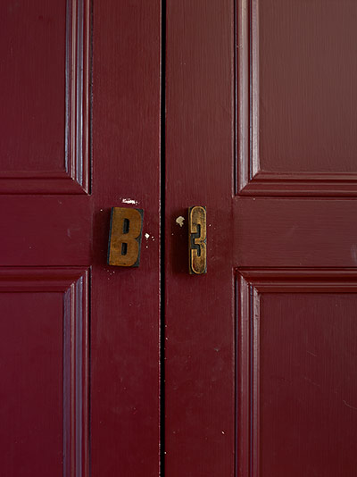 Homes - In With The Old: printers' blocks on red coloured doors