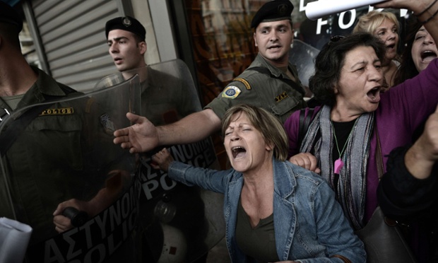 A passionate scene outside the Greek Finance Ministry in Athens as anti-austerity protesters are pushed back by riot police.