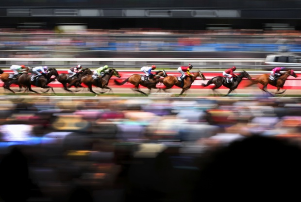 The runners and riders race along the straight of the Carnival Handicap during Melbourne Cup Day at Flemington Racecourse in Australia.