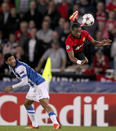 United: Manchester United's Patrice Evra takes to the air