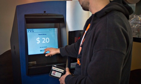 A customer uses the world's first ever permanent bitcoin ATM at a coffee shop in Vancouver, British Columbia.