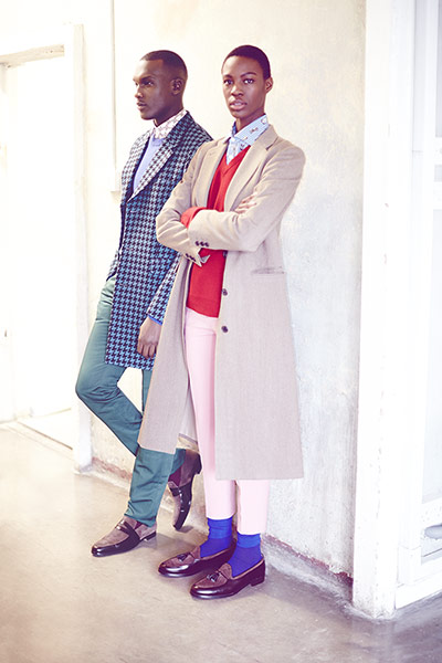 Fashion - boys and girls: a man and a woman standing against a wall