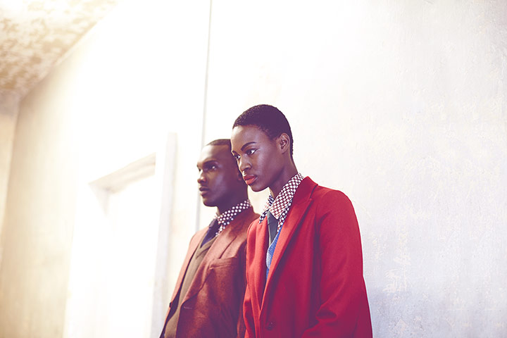 Fashion - boys and girls: man and woman in suits standing against white wall 