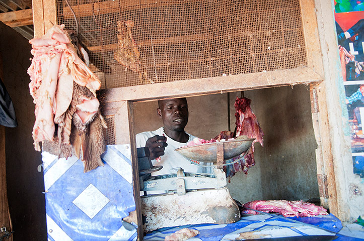 International Journalism: Man selling meat in a Ugandan butcher's