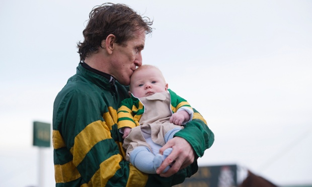 Tony McCoy kisses his baby son Archie