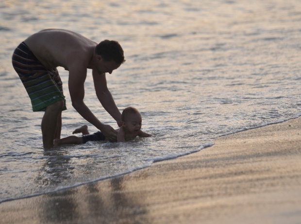 A man and his child on a beach in south China's Hainan Province