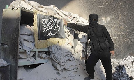 A fighter from Jabhat al-Nusra poses at a checkpoint in Aleppo