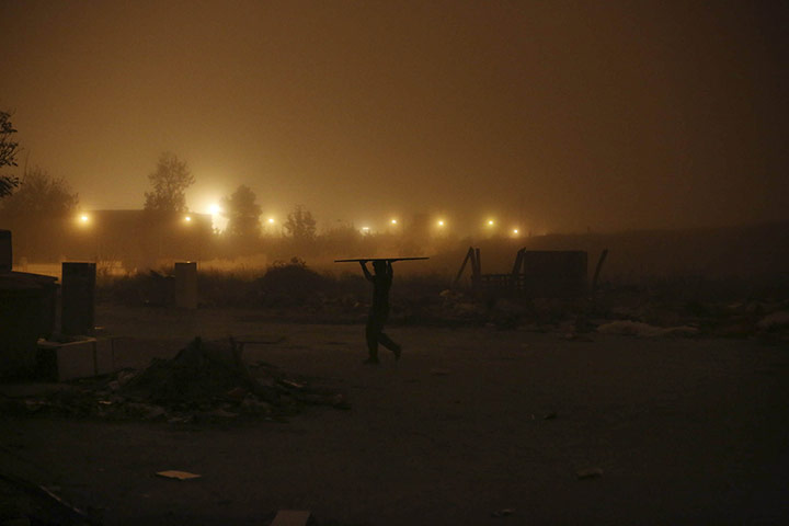 20 Photos: Cortes Vargas carries a wood panel to heat his home in Madrid