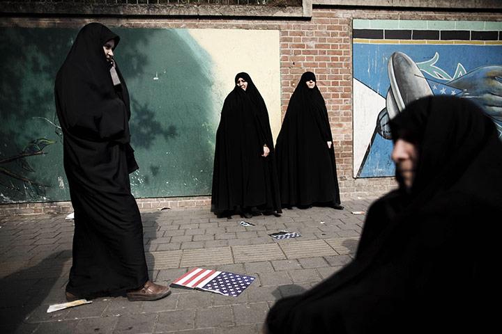 20 Photos: Iranian women stand next to the wall of former US embassy in Tehran