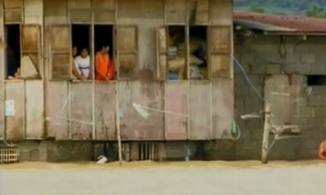 People trapped in a house by floodwaters in Mindoro