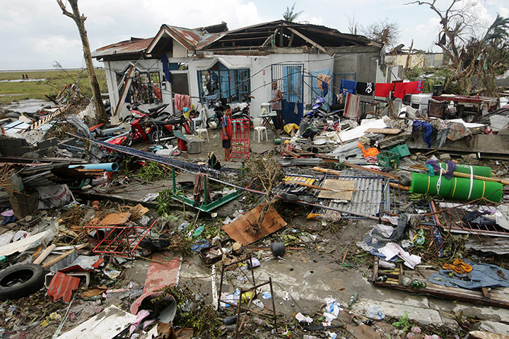 Typhoon Aftermath: A Filipino boy stands among the debris 