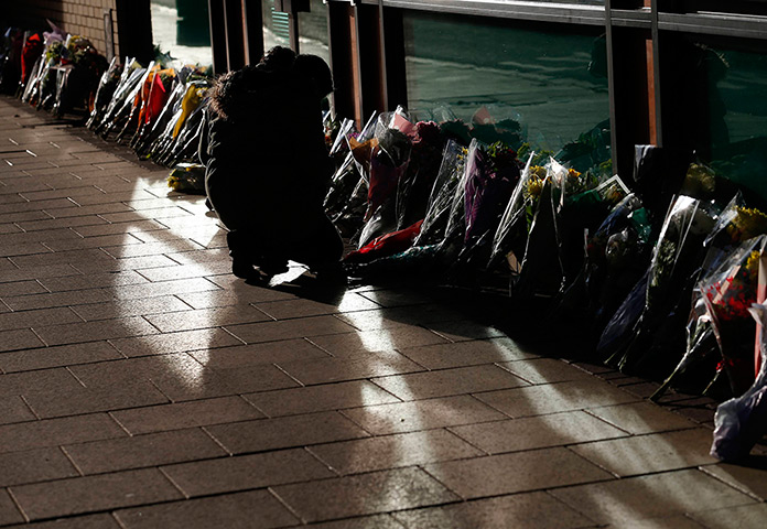 glasgow crash memorial: A well wisher places a bouquet near the Clutha Vaults pub in Glasgow