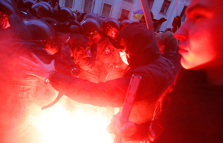 Ukraine protests: A flare is ignited as protesters clash with police