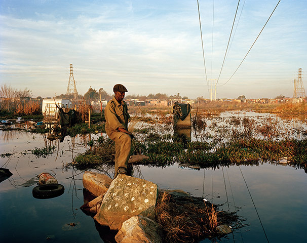 Big Pic - South Africa: man standing in flooded area 